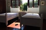 Recently Acquired Twin Beds, Glazed White; White Bookcase; Tole Shade Iron Lamp