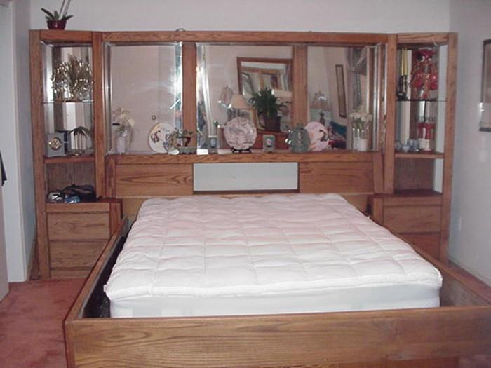 Large, room-size headboard with build in storage and mirrors