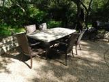 Outdoor dining: Travertine stone table and 8 resin wicker chairs