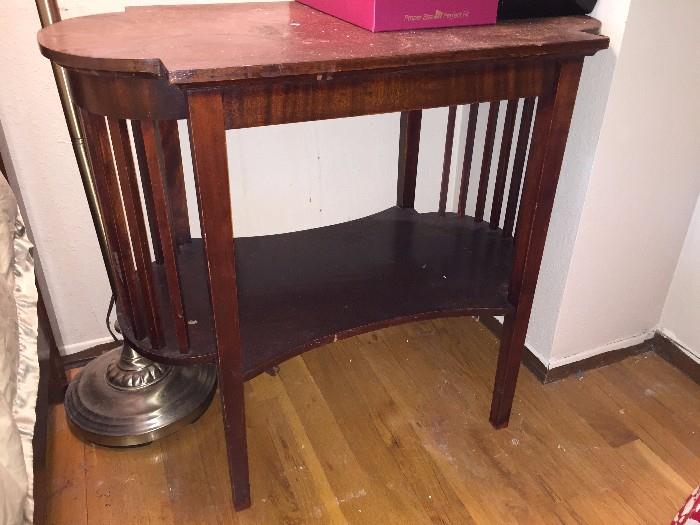 Antique side table with tapered legs and rounded edges