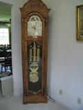 Howard Miller Grandfather Clock Triple Weight 1/4hour chime/silent option, Moon Phase, Oak Case Bonnet top side glass, glass front door model 611-019 82" tall