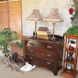 Antique chest with hand carved drawer pulls, accent shelving, wrought iron architectural accent pieces, hand blown glass birds, artificial plants, vintage and antique books, accent lamps