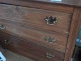 Oak chest of drawers. This one is found in the living room of the home and has been re-finished.