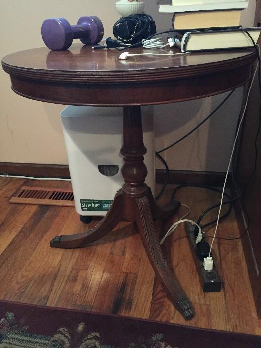 pedestal table with carved wood legs and ferrule