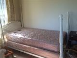 one of a pair of white twin beds