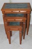 Three marble topped nesting tables.