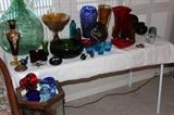 Tables filled with hand blown colored glass, Murano birds and hearts. Bohemian vase, Venetian vase and Depression glass.