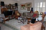 Living room, TV, stereo, CDs, hand blown glass, mid century furniture, nesting tables, original artwork.