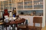 Walnut dining set, shelves filled with vintage and crystal stemware. Two dinner sets.