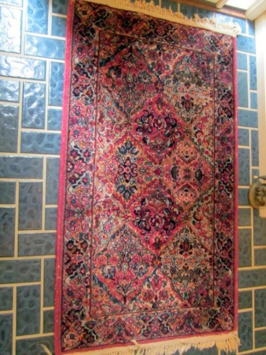 One of a pair of Sarouk area oriental rugs.