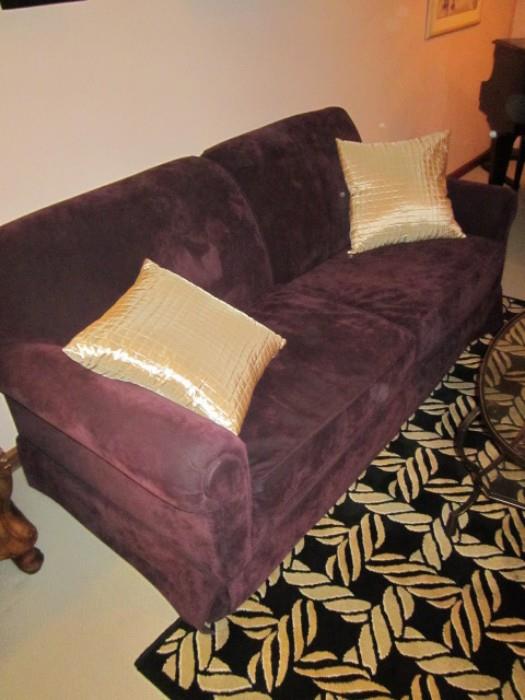 Sleeper sofa in plumb upholstery. 