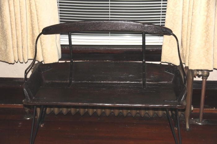 bench made from an antique buckboard seat