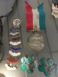 Assorted medals and other achievement pins