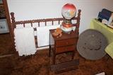 Antique bed frame, linens, basket, hand-painted electrified oil lamp, and small end table