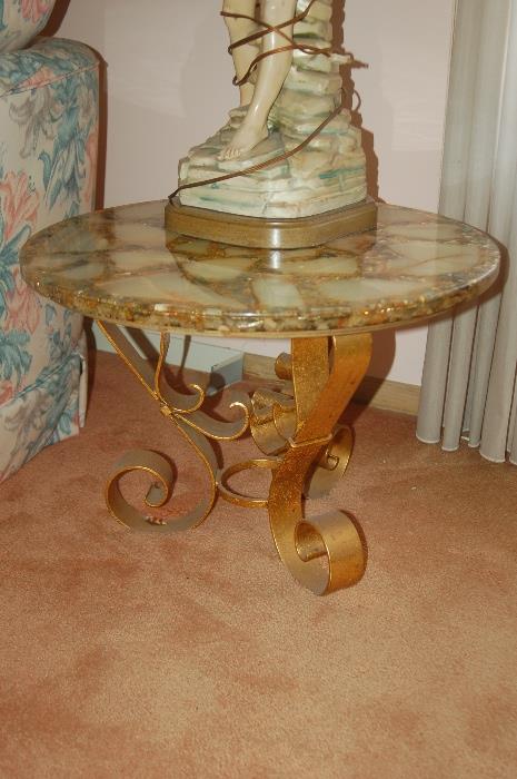 Two cast iron gold leafed end tables.