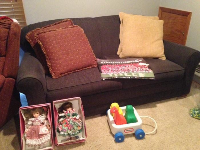 couch, toys, chiefs posters, dolls