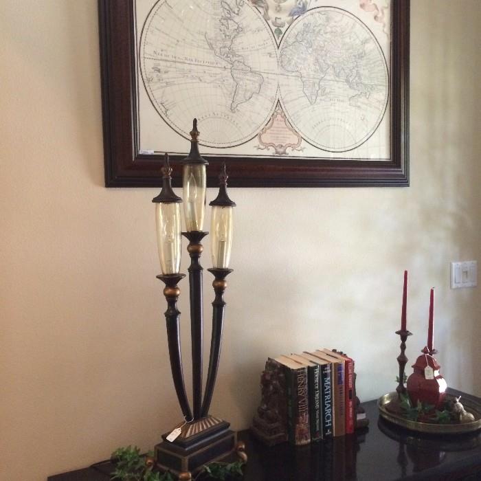  Three pronged lamp; framed "globe" of the world