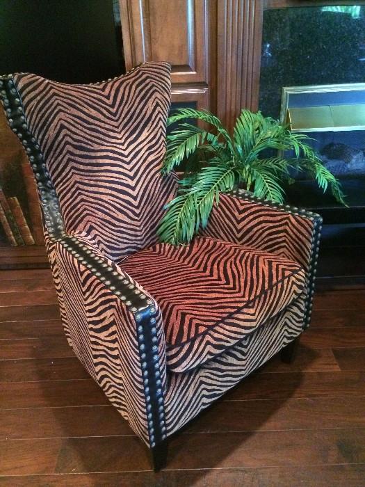   One of two brown & black "zebra" chairs