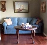 Cindy Crawford Home sofa, vintage cocktail table, original oils, antique oak clocks.