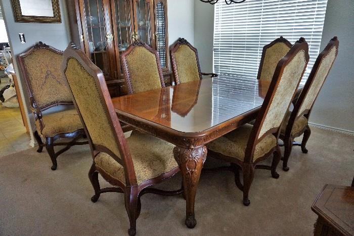Beautiful dining table and 8 chairs. It has one leaf and table pads, too!