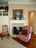 Wing chair, one of pair, room size rug, large framed prints
