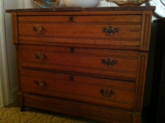 Walnut dresser with brown marble top
