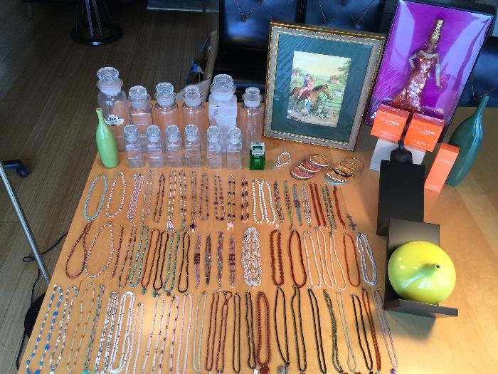 Hand beaded jewelry, apothecary jars, designer gold label barbies, 3 bottles of"happy clinique perfume.