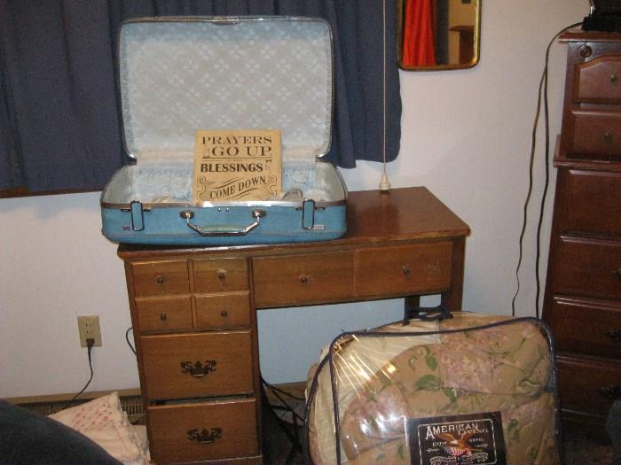 Vintage suitcase on vintage desk. Plus comforter
