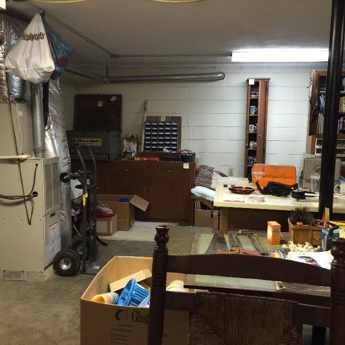 In background: Huge wooden storage cabinet with drawers and doors, large gray tool chest.  Hand trucks are sold.