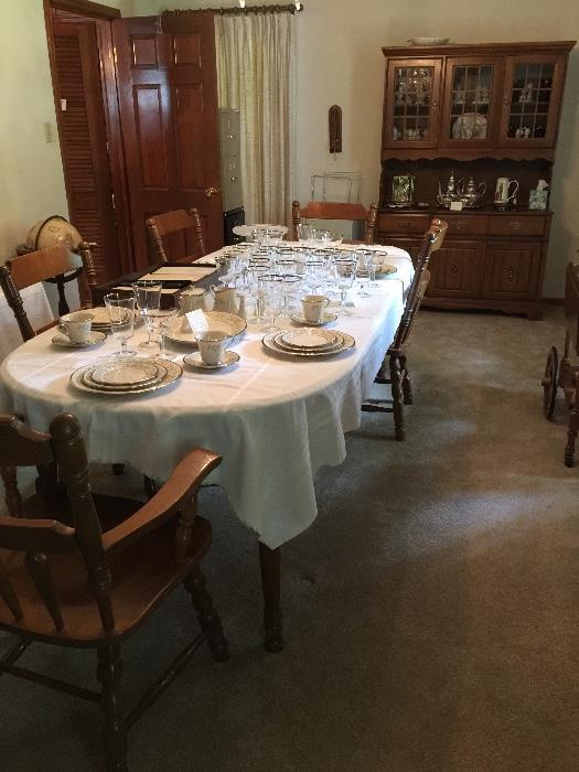 Bassett dining room table with 3 leaves, 5 chairs and china cabinet.  Lenox crystal in middle of table.  Lenox china has sold