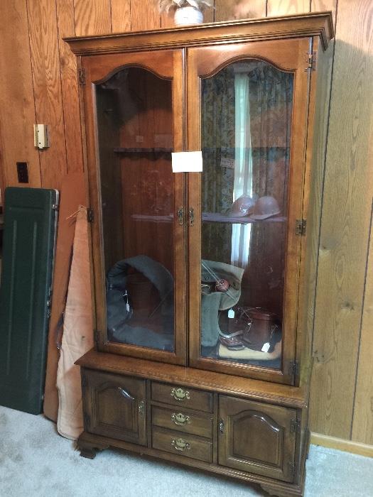 Large glass front gun cabinet, gun cases. Cabinet could easily be made into a beautiful curio cabinet with the addition of glass shelves. 