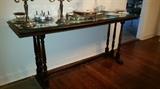 Solid Mahoghany sofa table with a glass protective top.