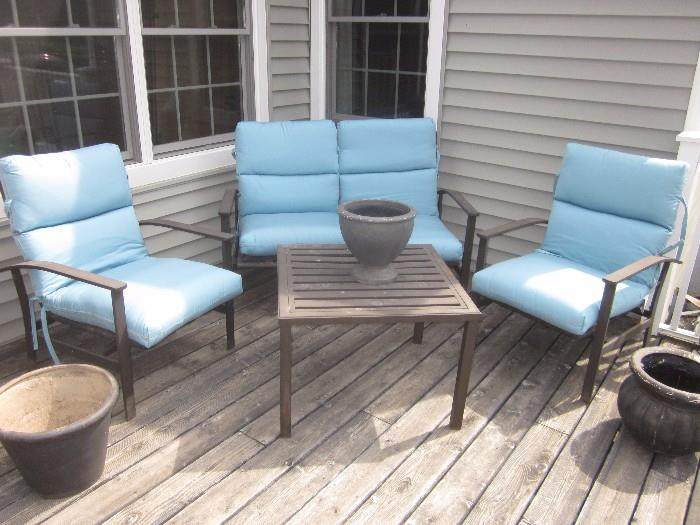 Patio seating area, sunbrella cushions. Table is firepit