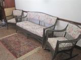 Three piece dark green wicker set- sofa, chair , rocker, area rug
