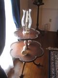 Two tier pie crust table and hurricane globe with brass candlestick