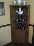 Vintage corner cabinet hutch with milk glass pieces, blue pitcher set, old Phillips Milk of Magnesia bottles . 
