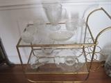 Brass and glass tea cart  with depression and Fostoria Century glassware on shelves