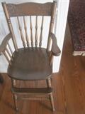 Vintage wood high chair with carving across back
