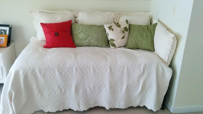 Lovely day bed, with jaunty pillows atop a crispy, white matelasse spread.                                                              You can create your very own beach cottage vignette, with all your children dressed in white shirts and khakis - very J. Crew!