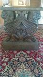 One of a pair of solid concrete gryphon dining room table bases