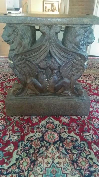 One of a pair of solid concrete gryphon dining room table bases