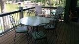 Wavy glass-topped wrought iron table, w/4 matching chairs. 