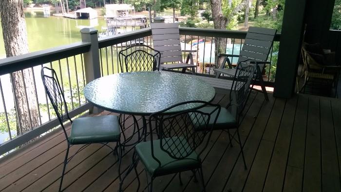 Wavy glass-topped wrought iron table, w/4 matching chairs. 