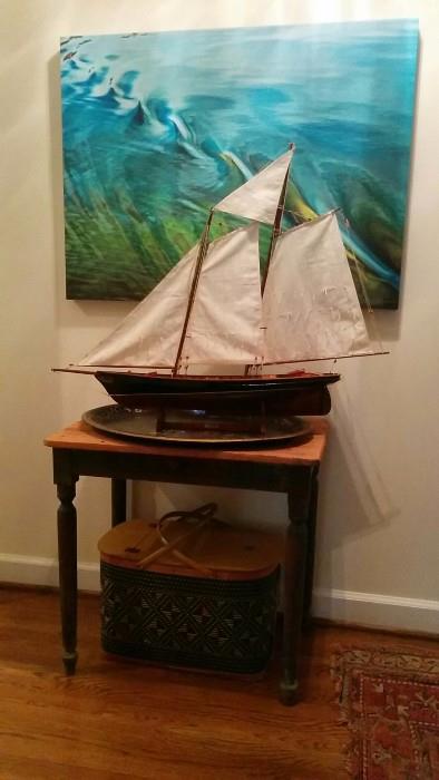 An original Marilyn Suriani artwork, a ships model "America", a perfect, chippy side table with heart pine top, a front drawer and Martian green legs. 