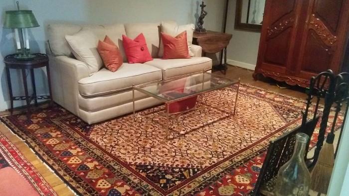 9' x 11' handwoven Persian rug, 100% wool. Queen size sleeper sofa by La-Z-Boy, featuring an air mattress that self inflates - very cool when that unexpected family member arrives, after having escaped from prison - again; brass Esther table, with beveled glass. 