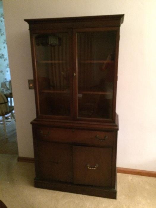Antique mahogany breakfront with two shelves, drawer and storage