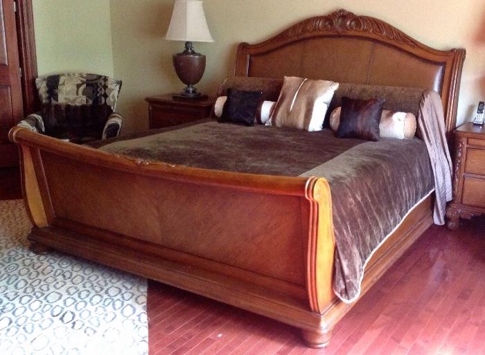Leather wood nailhead trim king sleigh bed. Bedding is not for sale. 