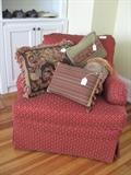 Comfy club chair and decorator pillows.
