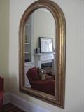 Handsome arched, gilded mirror.