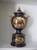 A three piece urn hand painted, signed and dated (1905)  It is Staffordshire earthenware.
